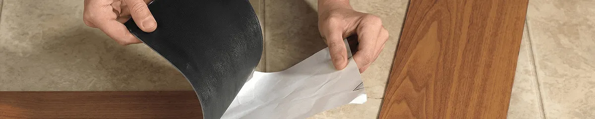 A professional installing vinyl flooring in Lowell, MA